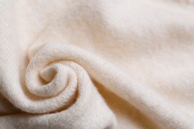 Photo of Soft beige knitted fabric as background, top view