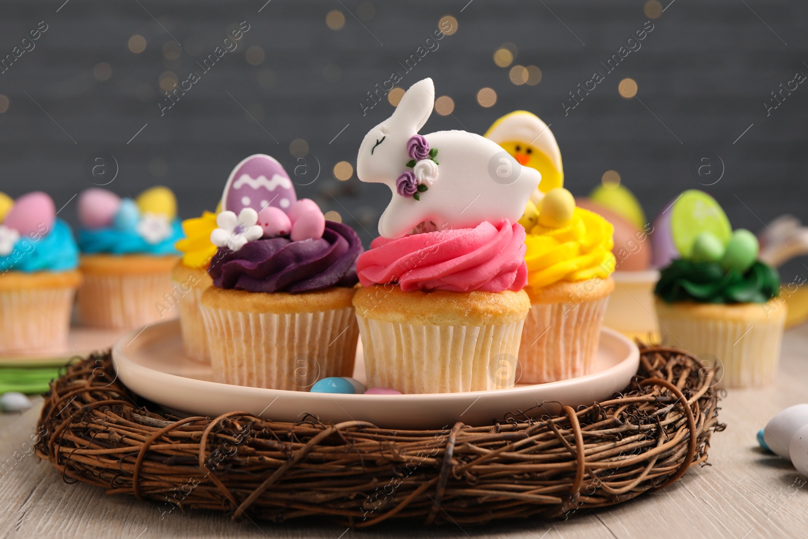 Photo of Tasty decorated Easter cupcakes on wooden table