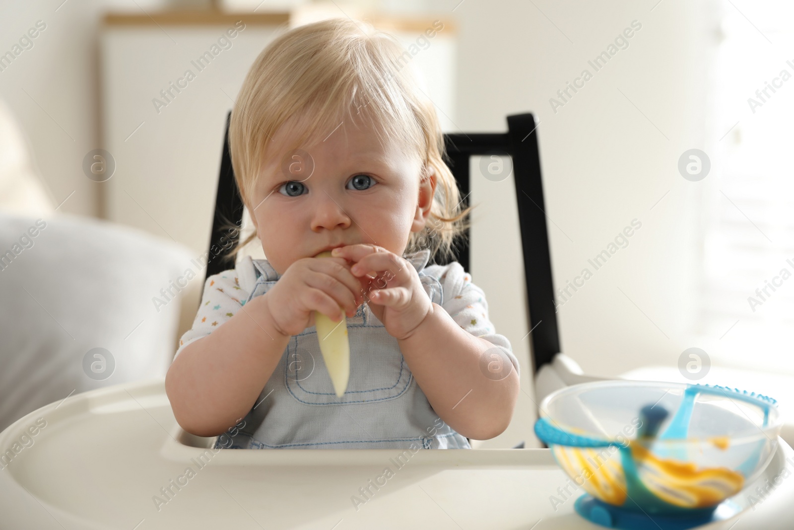 Photo of Cute little baby eating vegetable at home. Healthy food