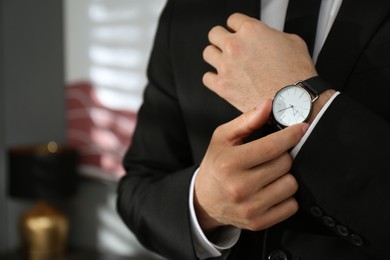 Photo of Businessman with luxury wrist watch indoors, closeup. Space for text