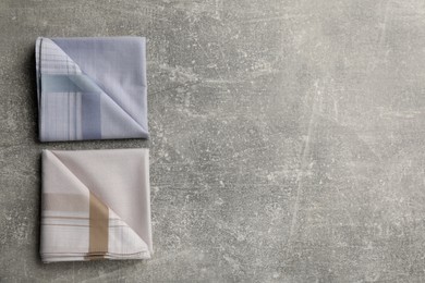 Stylish handkerchiefs on light grey table, flat lay. Space for text