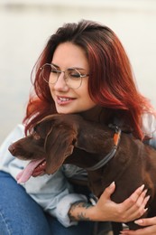 Woman with her cute German Shorthaired Pointer dog outdoors