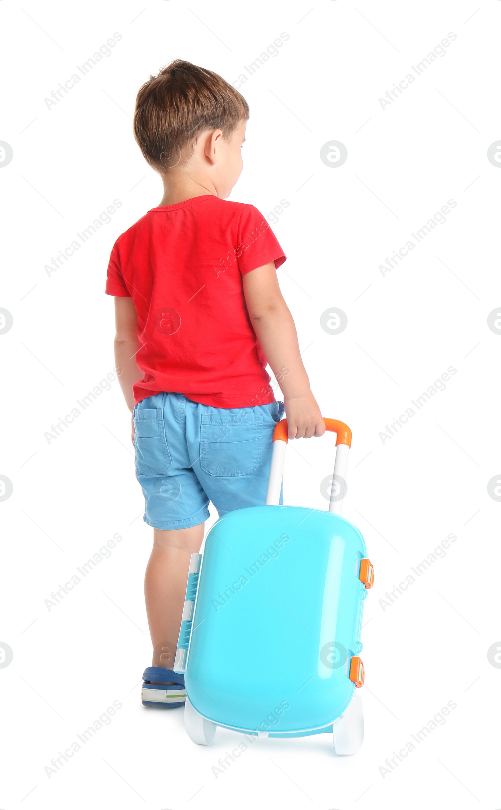 Photo of Cute little boy with blue suitcase on white background