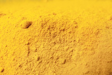 Photo of Aromatic turmeric powder as background, closeup view