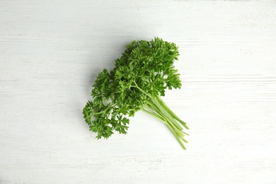 Photo of Bunch of fresh green parsley on wooden background, top view