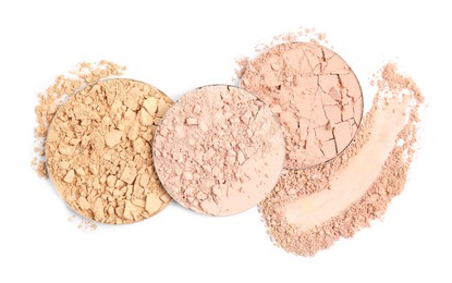 Photo of Different face powders and swatch on white background, top view