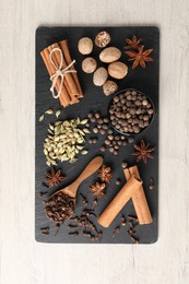 Photo of Different spices on wooden table, top view