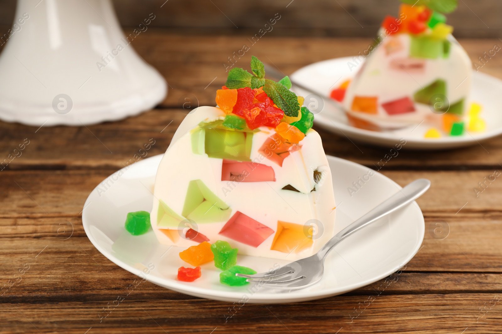 Photo of Delicious broken glass jelly dessert on wooden table