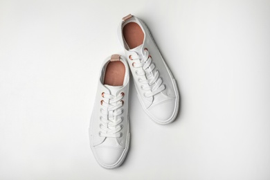 Photo of Pair of casual shoes on white background