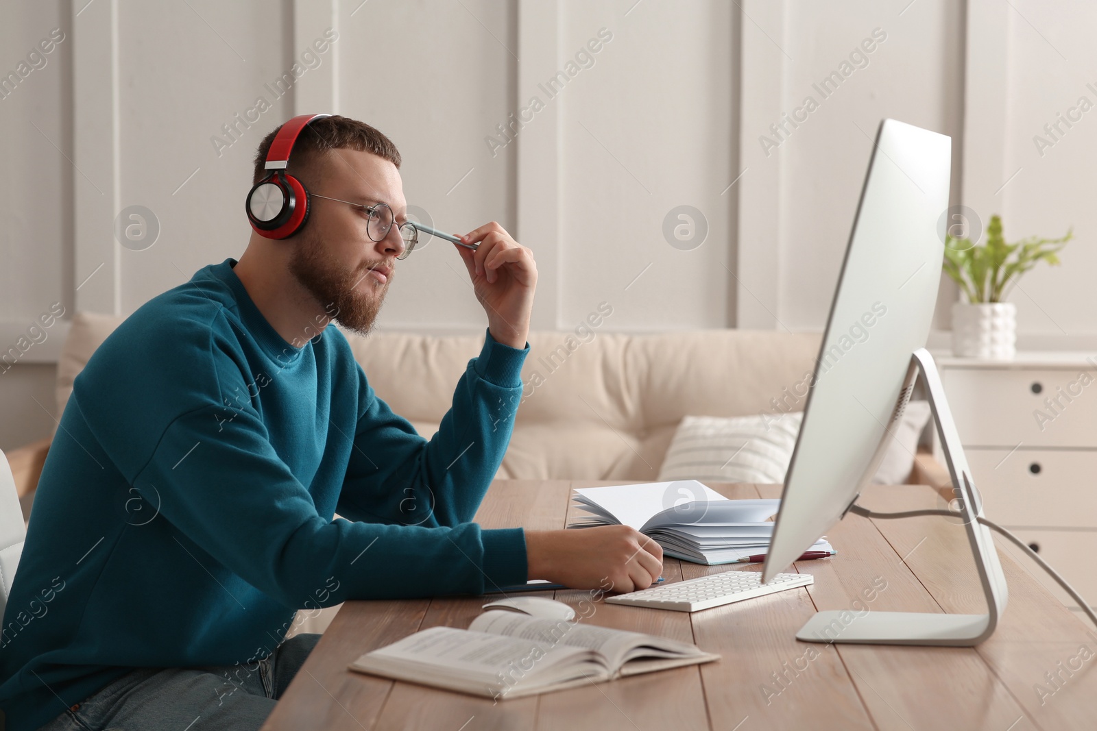 Photo of Online test. Man studying with computer at home