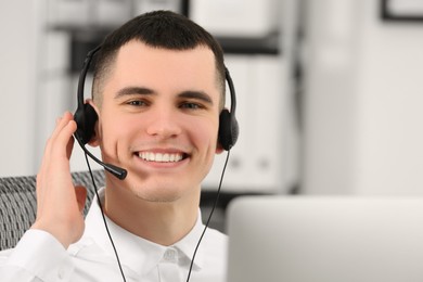 Photo of Hotline operator with headset working in office, space for text