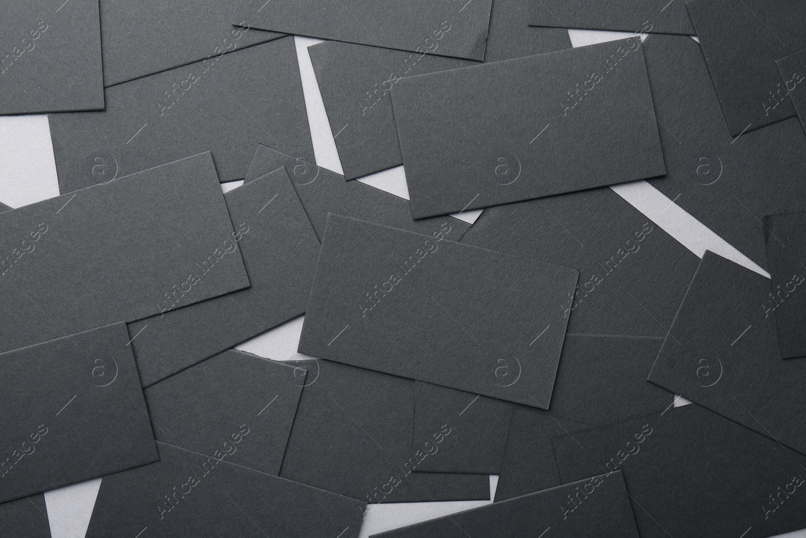 Photo of Blank black business cards on table, flat lay. Mockup for design