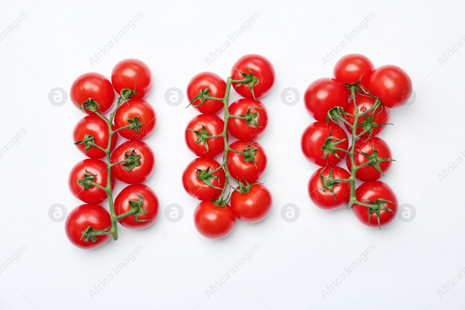 Photo of Flat lay composition with ripe tomatoes on light background