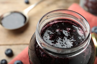 Photo of Jar of delicious blueberry jam, closeup view