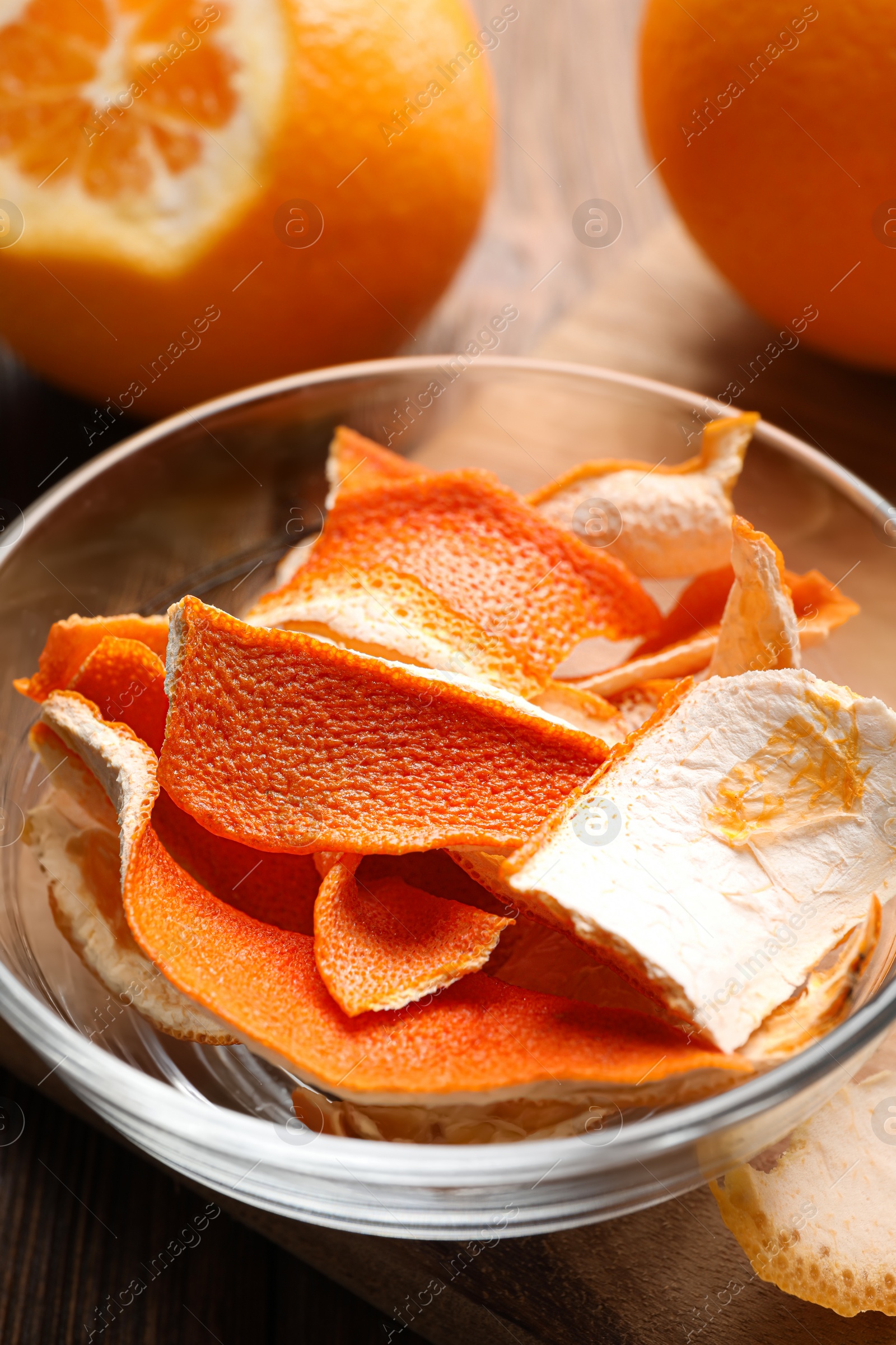 Photo of Dry orange peels on wooden table, closeup