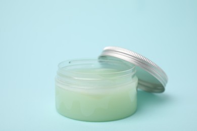 Photo of Jar of petroleum jelly on light blue background