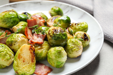 Image of Delicious fried Brussels sprouts with bacon on plate, closeup