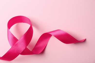 Photo of Pink ribbon on color background. Breast cancer awareness concept