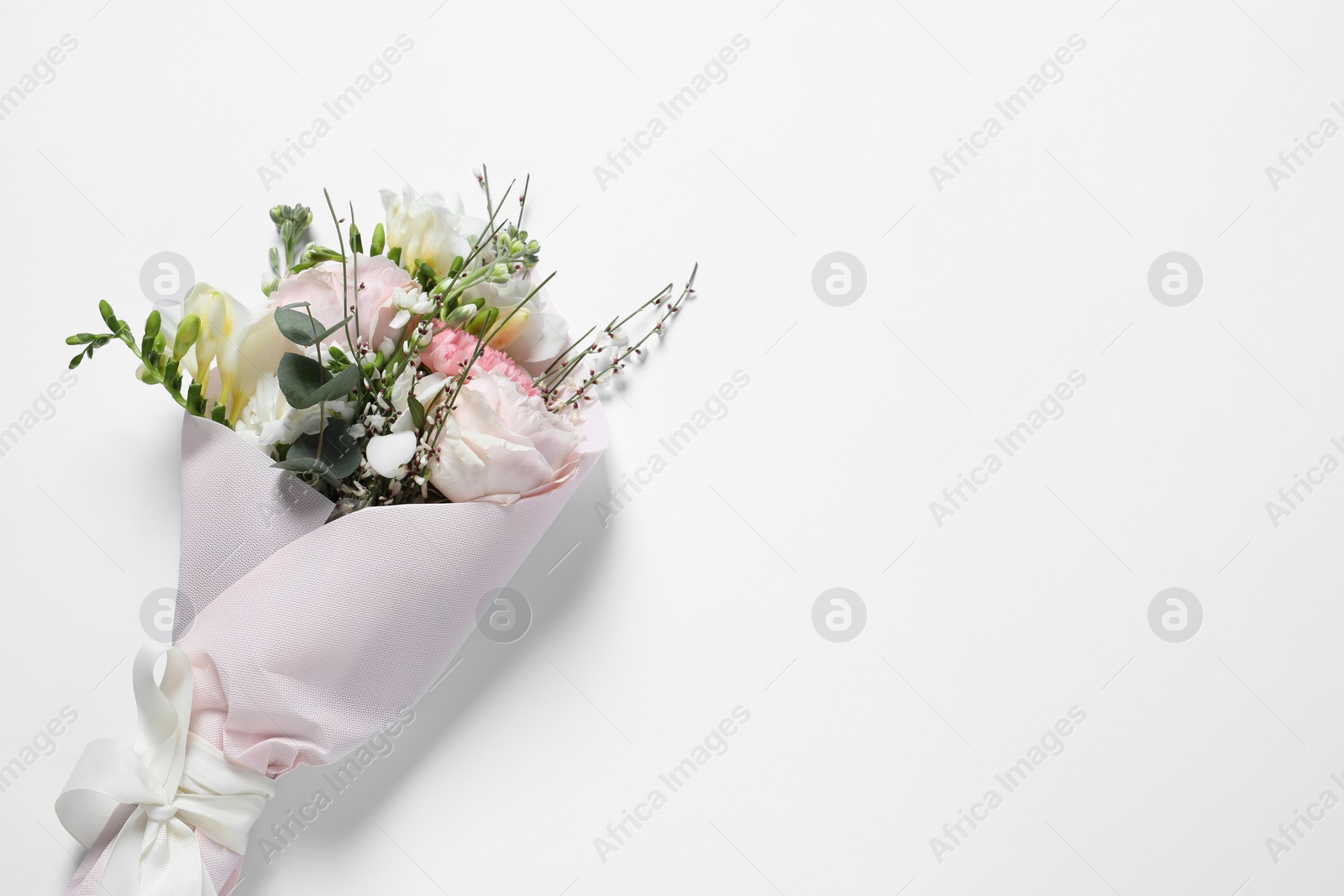 Photo of Bouquet of beautiful flowers on white background, top view. Space for text