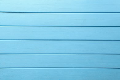 Texture of light blue wooden surface as background, top view