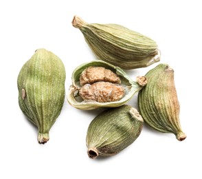 Photo of Dry green cardamom pods on white background, top view