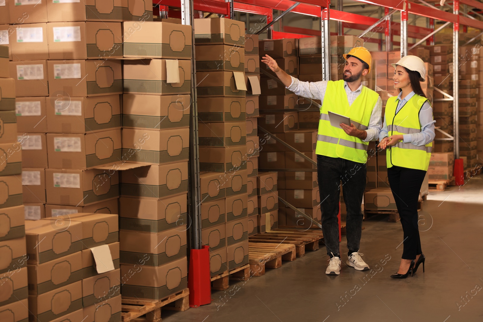 Image of Manager and worker at warehouse. Logistics center