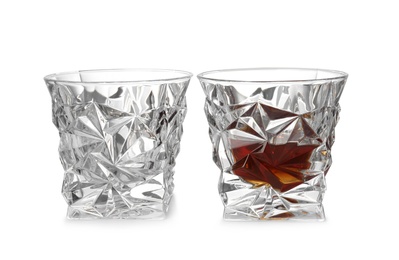 Photo of Empty and full whiskey glasses on white background