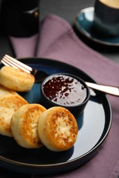 Delicious cottage cheese pancakes with jam on table