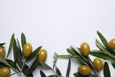 Photo of Twigs with olives and fresh green leaves on white background, flat lay. Space for text