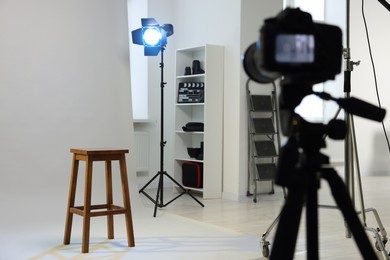 Camera, stool and different equipment for casting in studio, selective focus