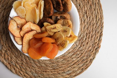Photo of Bowl with different dried fruits on white background, top view