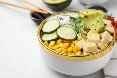 Photo of Delicious poke bowl with vegetables, tofu, avocado and microgreens on white tiled table, closeup. Space for text
