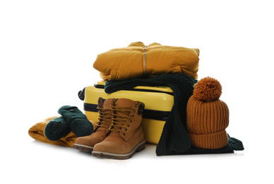 Photo of Suitcase with warm clothes isolated on white. Winter vacation