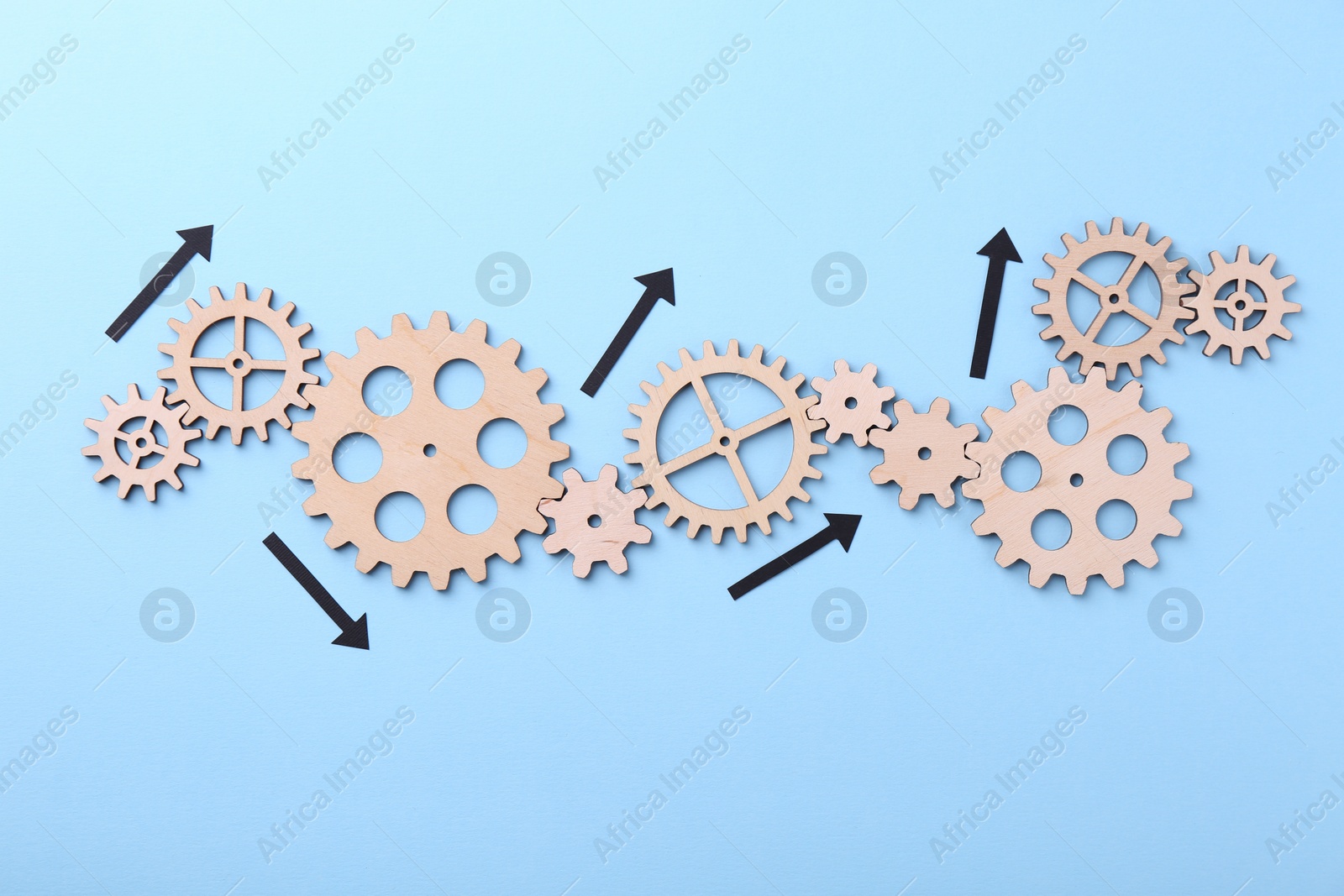 Photo of Business process organization and optimization. Scheme with wooden figures and arrows on light blue background, top view