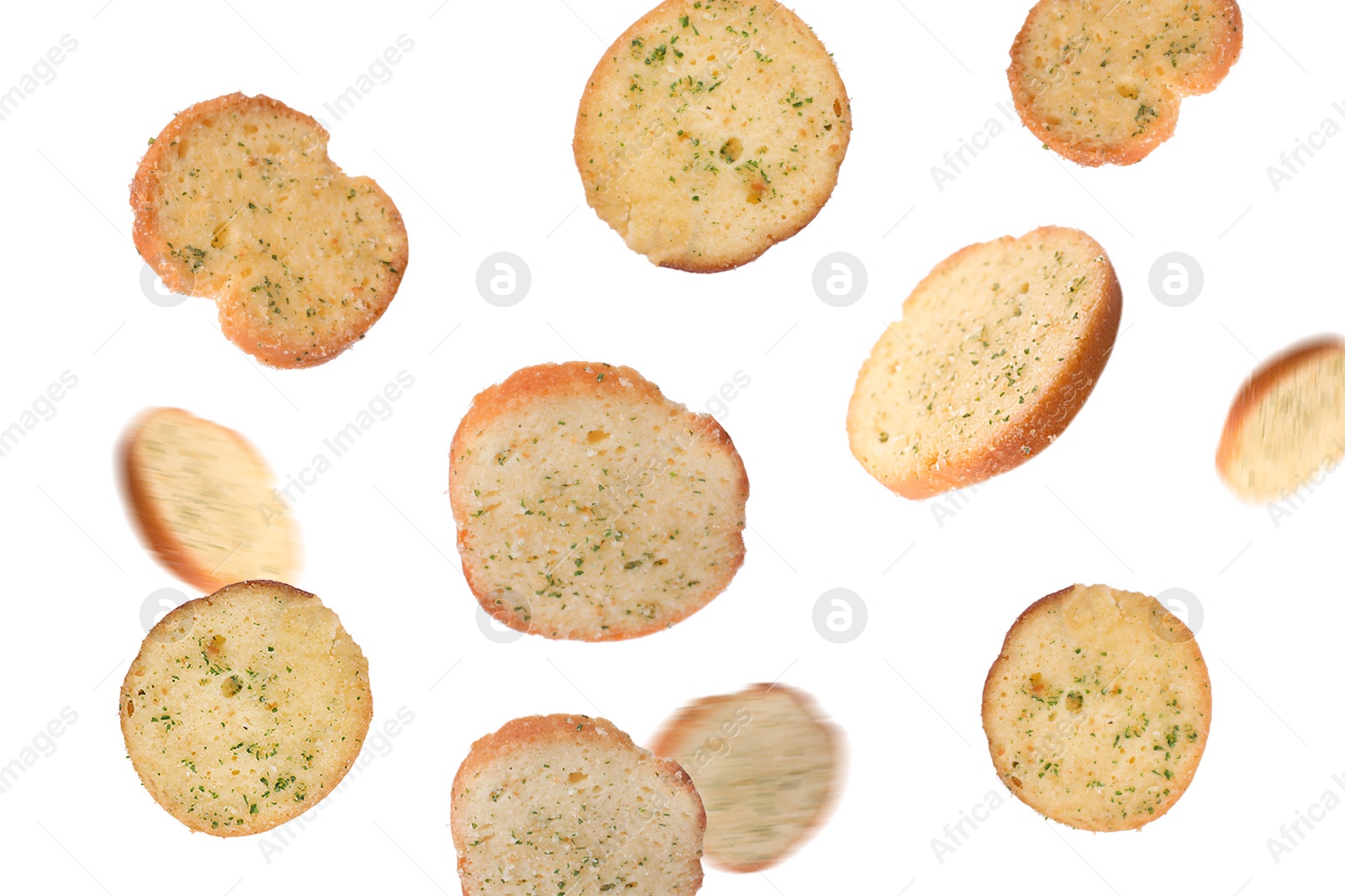 Image of Delicious crispy rusks falling on white background
