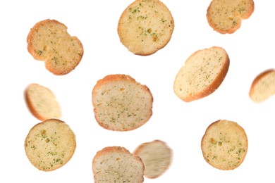 Delicious crispy rusks falling on white background