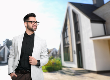 Image of Real estate agent against modern house. Space for text