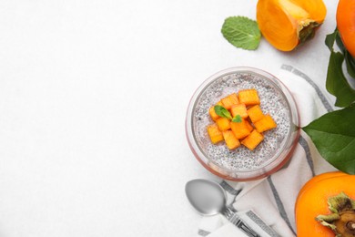 Photo of Delicious dessert with persimmon and chia seeds on table, flat lay. Space for text