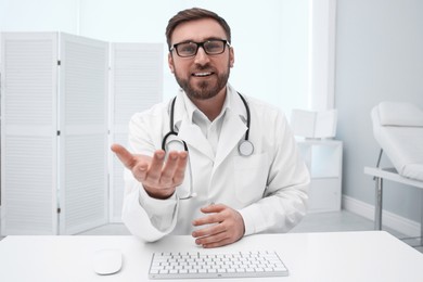 Pediatrician consulting patient using video chat in clinic, view from webcam