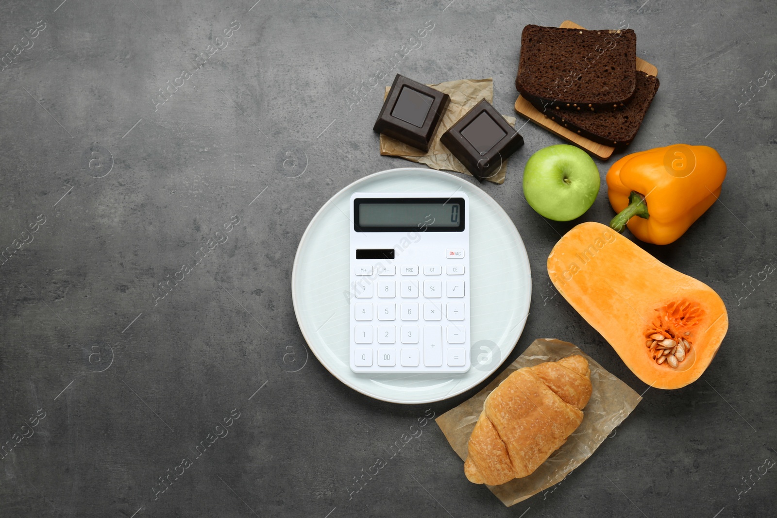 Photo of Calculator and food products on dark grey table, flat lay with space for text. Weight loss concept