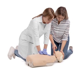 Photo of Doctor in uniform demonstrating first aid on mannequin against white background