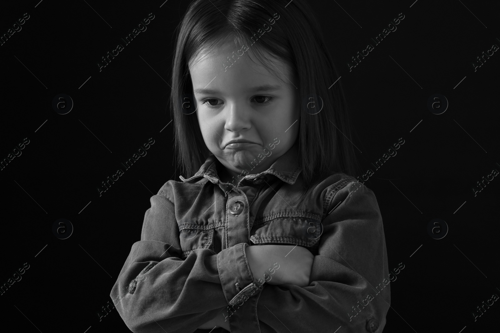 Photo of Portrait of sad girl on dark background, closeup. Black and white effect
