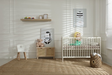 Photo of Light baby room interior with comfortable crib
