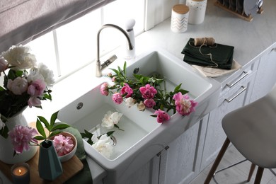Beautiful kitchen counter design with fresh peonies
