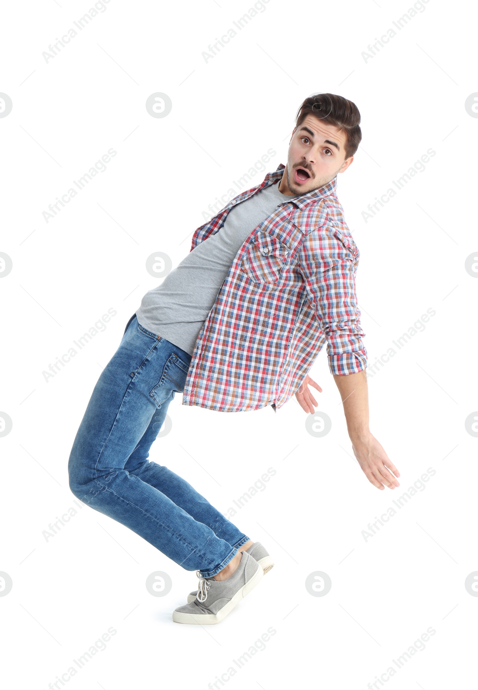 Photo of Young man attracted to magnet on white background