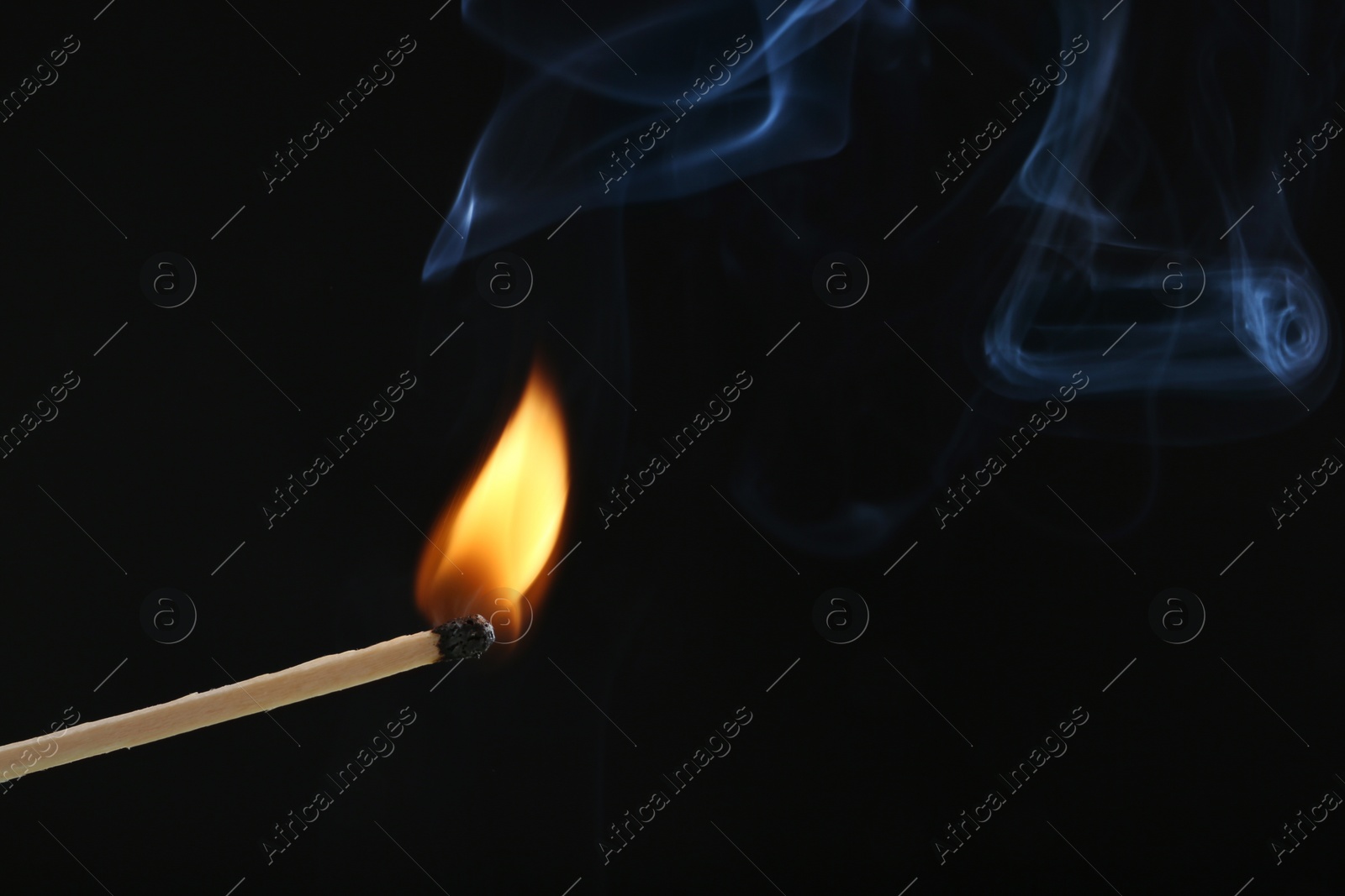 Photo of Burning match on dark background, space for text