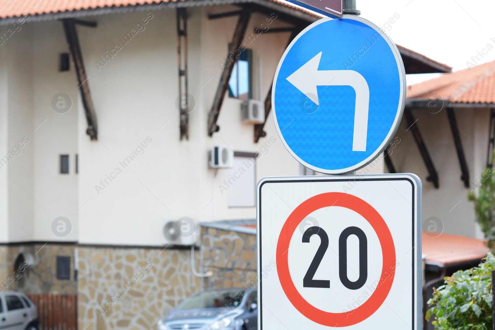 Photo of Post with traffic signs Speed Limit and Turn Left Ahead outdoors. Space for text