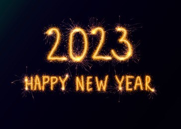 Image of 2023 Happy New Year made of sparkler on dark background. Greeting card design