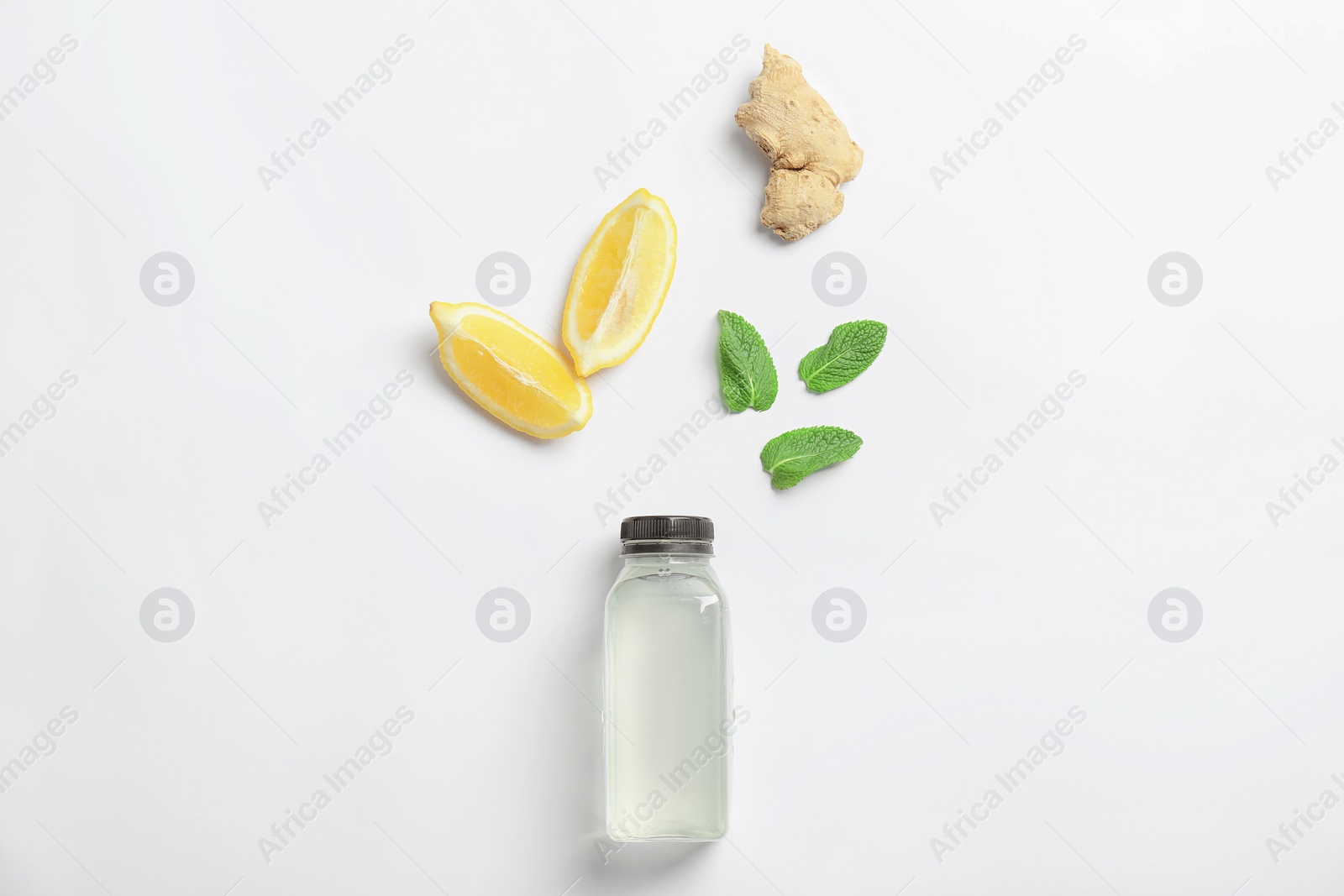 Photo of Flat lay composition with delicious natural lemonade on white background