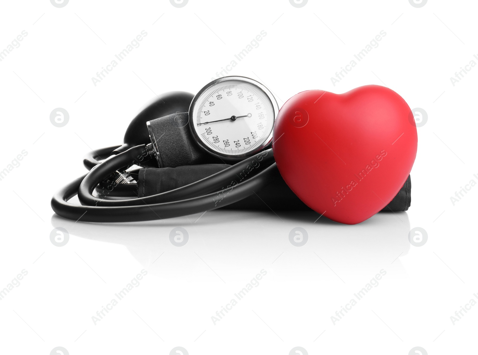 Photo of Blood pressure meter and toy heart on white background